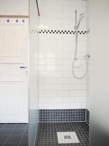 a bathroom with a shower with a glass door at Poeler Inselhaus in Kaltenhof +27 photos