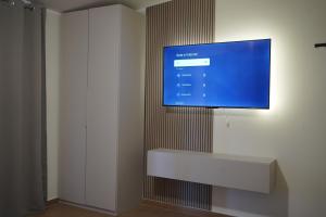 a flat screen tv hanging on a wall at TROPICAL ROOMS Vista Mare in Cirò Marina