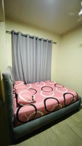 a bedroom with a pink bed with a curtain at Simon donkor 2 in Kumasi