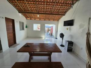 a room with a wooden table in the middle of a room at Descanso das Águas in Santo Amaro