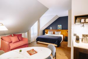 a hotel room with a bed and a chair at RockyPop Grenoble Hotel in Grenoble +52 photos