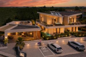 an aerial view of a house with two cars parked in front at Haven Luxury Living in Keramoti