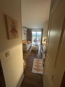 an open door to a living room with a couch at Cocon dans le village cap esterel in Saint-Raphaël +14 photos