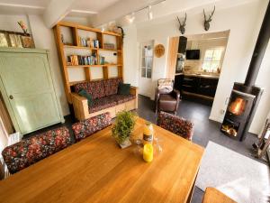 a living room with a table and a couch at Villa Mar veluwe in Ermelo