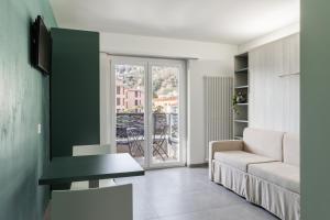 a living room with a couch and a table at By THE LAKE in Muralto