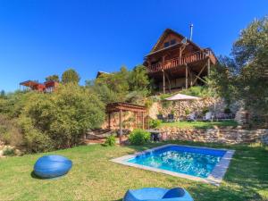 a house with a swimming pool in the yard at Mountain Cabin private hot tub and swimming pool in Wolseley
