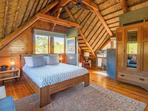 a bedroom with a bed in a wooden cabin at Mountain Cabin private hot tub and swimming pool in Wolseley +40 photos
