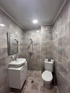 a bathroom with a white toilet and a sink at Червената къща in Hisarya +21 photos