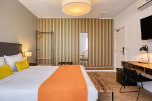 a hotel room with a large bed and a desk at Beverly Hills Hotel in Brussels