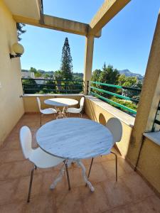 a table and chairs on a balcony with a view at Villa Cristina in Casteldaccia