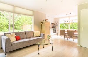 a living room with a couch and a table at De Vlinderstruik | 4 persons in Gasselte