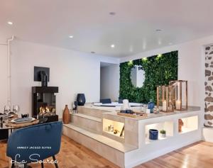 a living room with a fireplace and a couch at Suites avec Jacuzzi Privé & Terrasse - Vieille Ville d'Annecy in Annecy