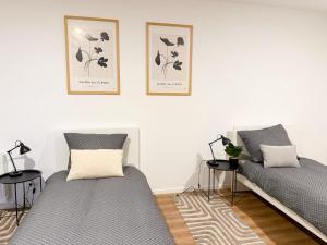 two beds sitting next to each other in a room at Lucky Strike Hostel in Bad Oldesloe