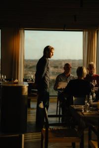 a man standing in front of a window in a restaurant at Elements Terschelling by Dutchen in Midsland +157 photos