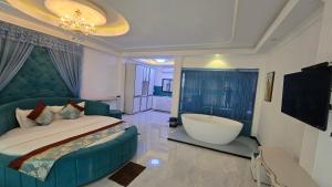 a bedroom with a large bed and a bath tub at Golden Ridge Sigiriya in Dambulla