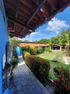 a view of the garden from the porch of a house at Pousada dos Mundos1 in Conde