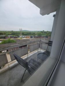 a balcony with a chair sitting on top of a building at The Cozy Velvet in Ocna-Mureşului