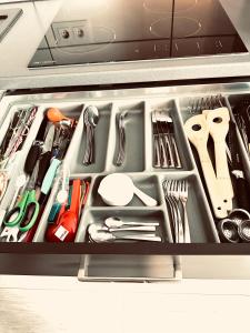 a drawer full of kitchen utensils in a container at Apartment klein, fein, ruhig und gemütlich in Bochum