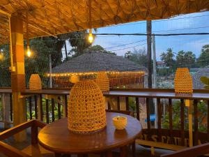 a wooden table on a balcony with at Casa Moon Trincomalee Beach House in Trincomalee +72 photos