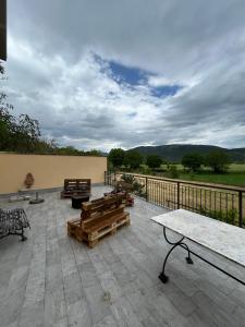 a patio with benches and tables on a balcony at Villa Nina in Caporciano