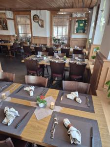 a dining room with wooden tables and chairs at Gasthof Hirschen in Wilderswil in Wilderswil +15 photos