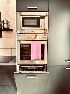 a kitchen with an oven and a microwave at Apartment klein, fein, ruhig und gemütlich in Bochum +14 photos