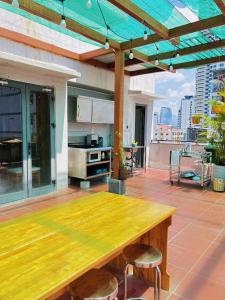 a wooden table and two stools on a patio at Zesty Hostel & Bistro in Nha Trang