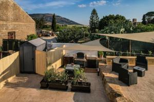 a patio with a tent and a table and chairs at Casale Sammartano - Appartamenti con piscina comune in Ummari