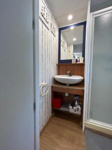 a bathroom with a sink and a mirror at El Moll Grec in L'Escala +30 photos