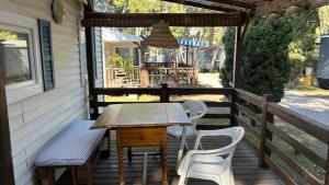 a table and chairs on the porch of a house at El Moll Grec in L'Escala
