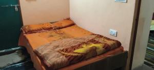 a unmade bed in a room with at Chaukhamba hill homestay in Ukhimath +7 photos