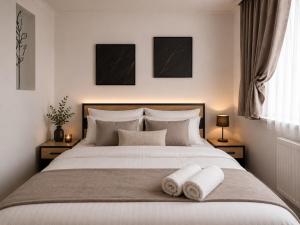 a bedroom with a bed with two towels on it at Апартаменти 2-кім Тарнавського in Ternopil