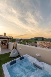 a hot tub on the roof of a house at Enclave Luxury Apartments in Áyios Kírikos