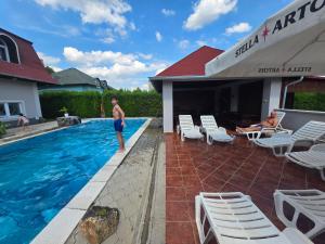 a man standing in the pool at a resort at Stars Palić in Palić