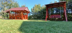 a gazebo and a bench in a park at На Пагорбі in Mykulychyn +23 photos