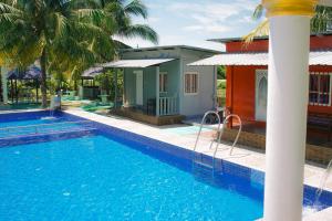 a swimming pool in front of a house with a resort at Mersing Barokahhill Beach Resort in Kampong Tanjong Resang