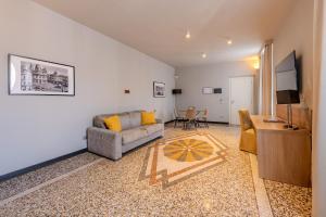 a living room with a couch and a table at HNN Luxury Suites in Genoa