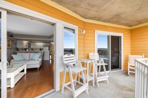 a living room with a couch and a table and chairs at Playa Flamingo #302 in Ocean City +22 photos