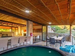 an outdoor patio with a pool and a table and chairs at Wild Olive Cottage with Hot tub in Wolseley
