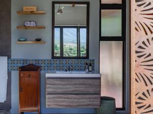 a bathroom with a sink and a mirror at Mountain Bungalow private hot tub&swimming pool in Wolseley +22 photos