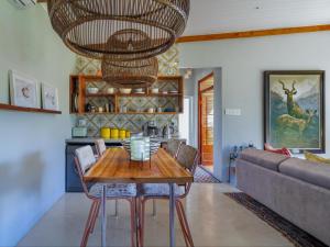 a dining room with a table and a couch at Mountain Bungalow private hot tub&swimming pool in Wolseley