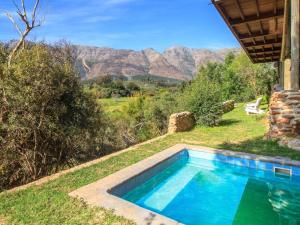 a swimming pool with a view of the mountains at Mountain Bungalow private hot tub&swimming pool in Wolseley