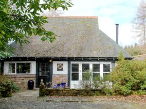 a small brick house with a gray roof at Gareside Lodge in Rhu +3 photos