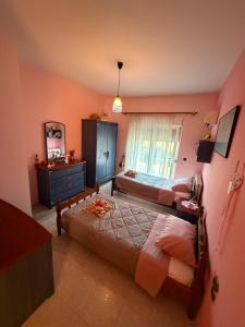 a bedroom with two beds and a mirror at Silver View House in Theologos