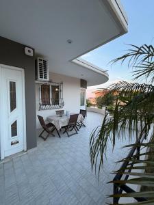 a patio with chairs and a table and a table at Silver View House in Theologos
