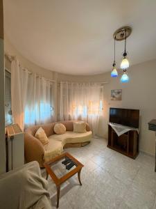 a living room with a couch and a table at Silver View House in Theologos