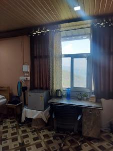 a room with a desk and a large window at Adaara Retreat - Pet Friendly Cottages, Almora in Almora +122 photos