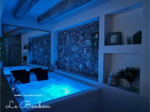 a blue room with a hot tub in it at Suites avec Jacuzzi Privé & Terrasse - Vieille Ville d'Annecy in Annecy