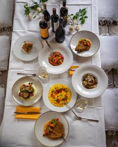 a white table with plates of food on it at Bioagriturismo il cerreto in Pomarance