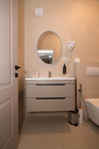 a bathroom with a sink and a mirror at Hotel Dimora 1927 in Tirana +28 photos
